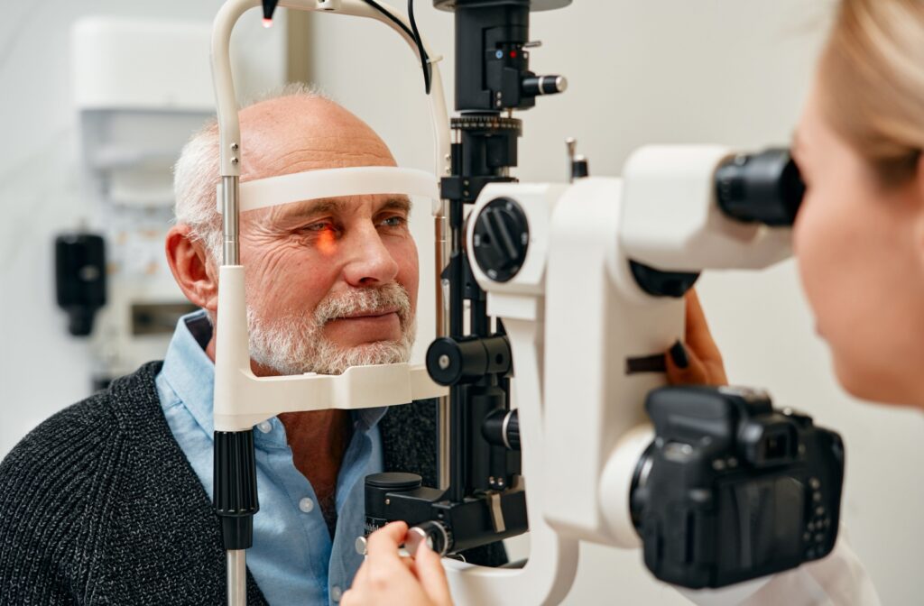 A person has their eye examined by an optometrist using a slit lamp.